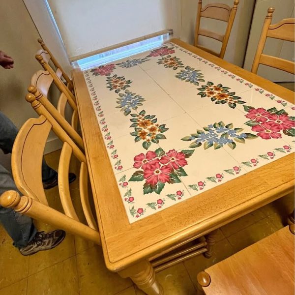 TABLE with hand painted tiles. And six chairs.